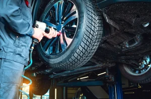 Person replacing a tire on a vehicle