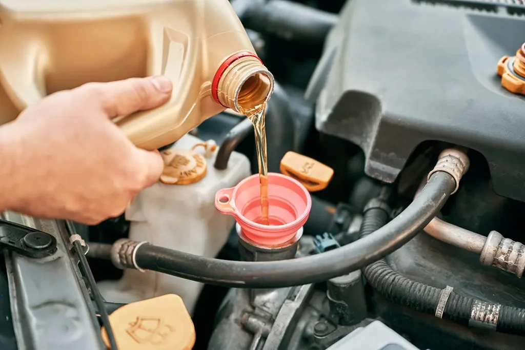 Oil pouring into funnel for an oil change